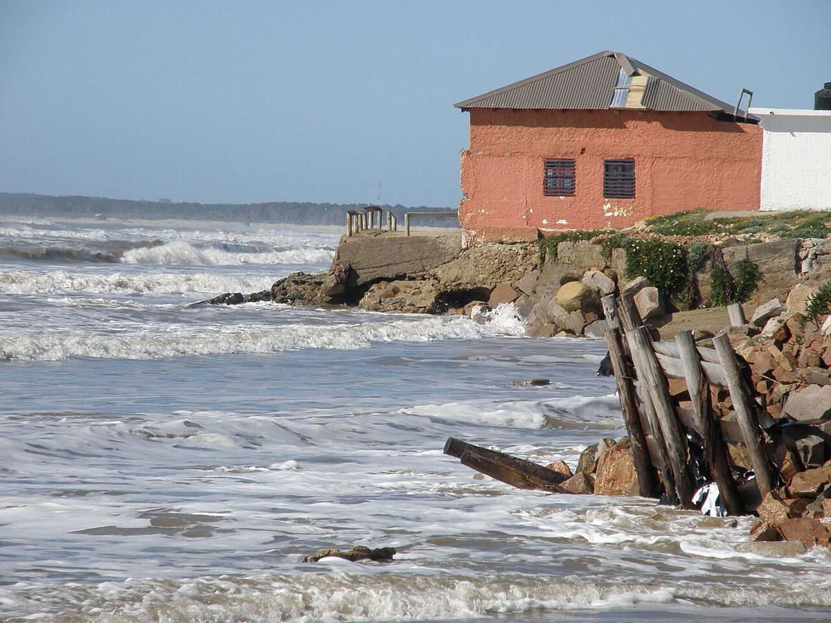 The wooden boardwalk and fishing boats on the beach at Aguas Dulces, Uruguay