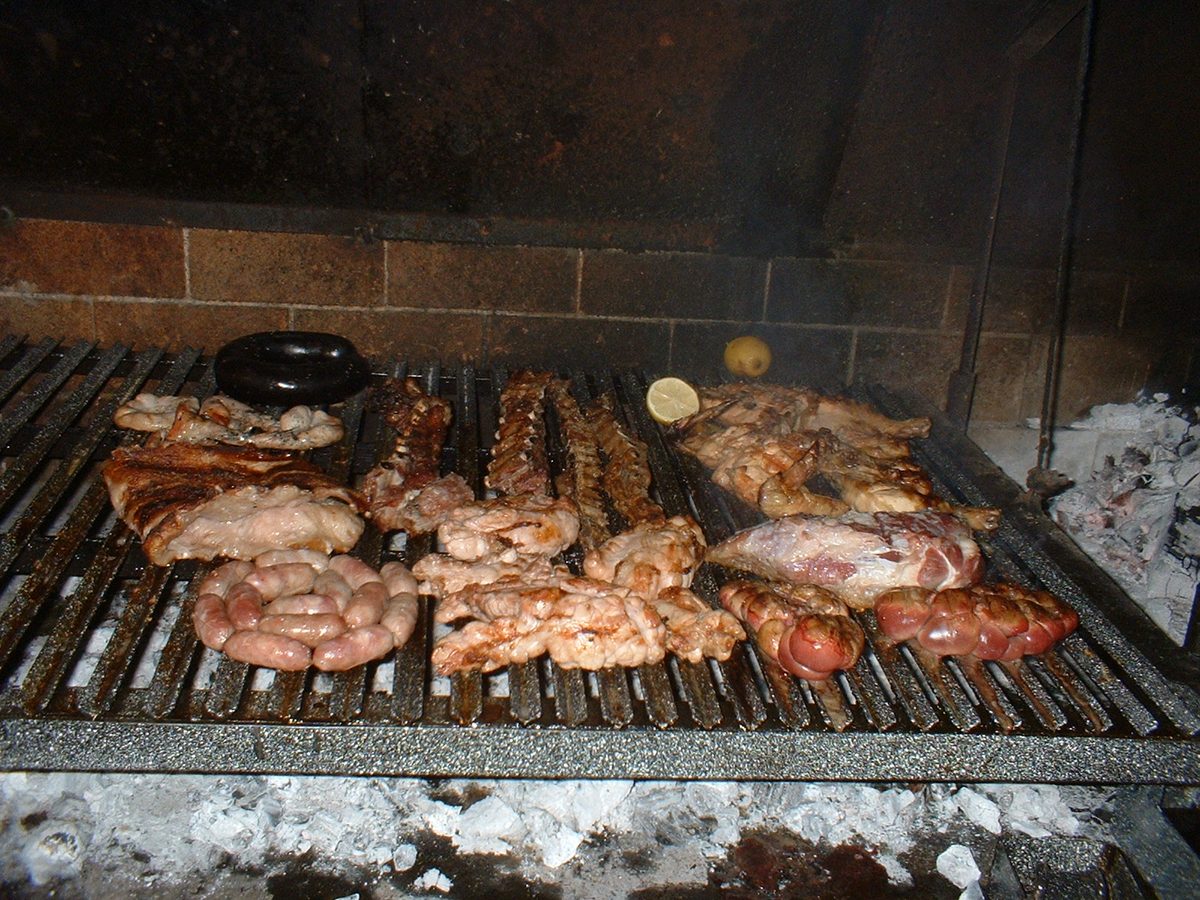 Asado grilling over wood embers at a parrilla - the centerpiece of Uruguayan food culture