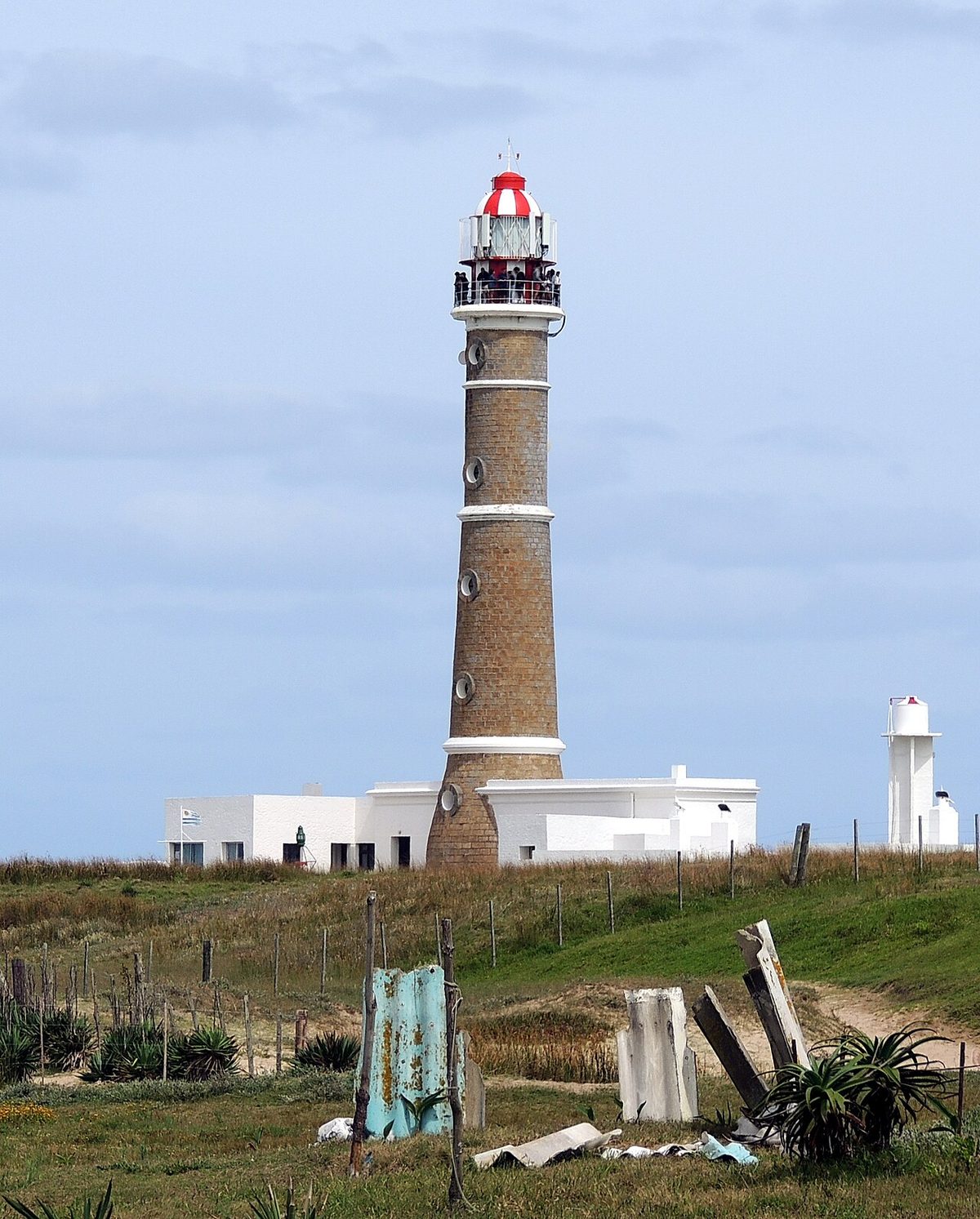 The candy-striped lighthouse rising above the rocky point on the Rocha coast of Uruguay