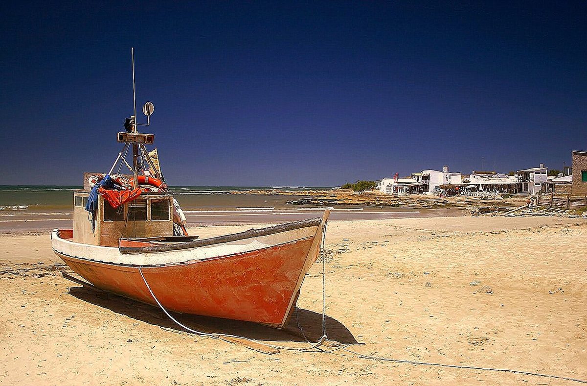 Sandy footpaths winding between rustic wooden fishing shacks in the centre of the village