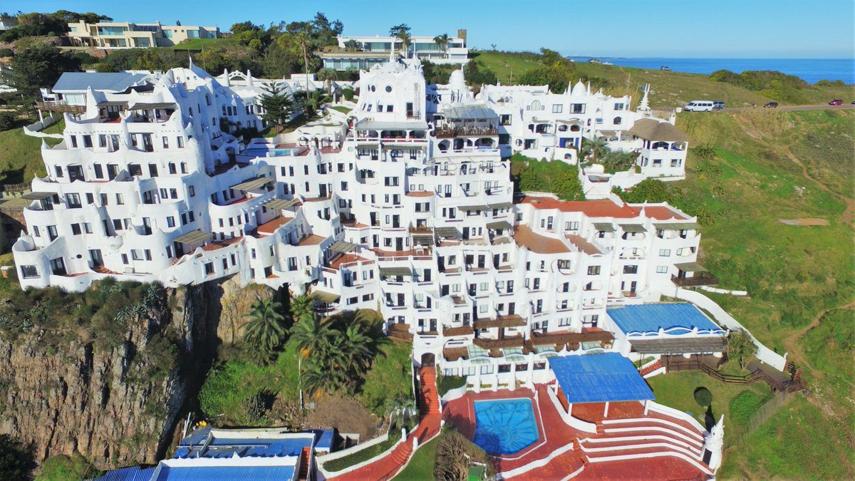 The white sculpted terraces of Casapueblo glowing at sunset near Punta Ballena