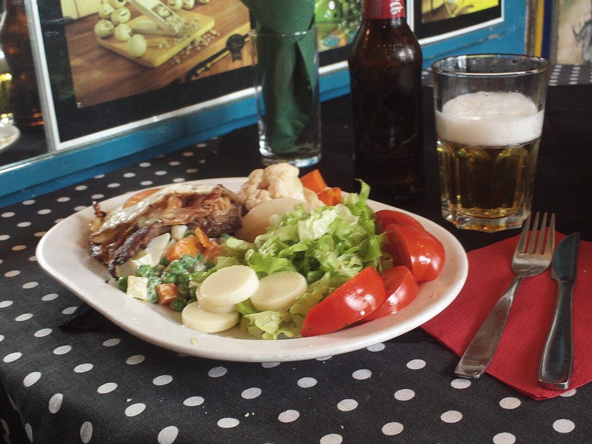 A plated steak sandwich with no bread, served with fries and egg in Uruguay