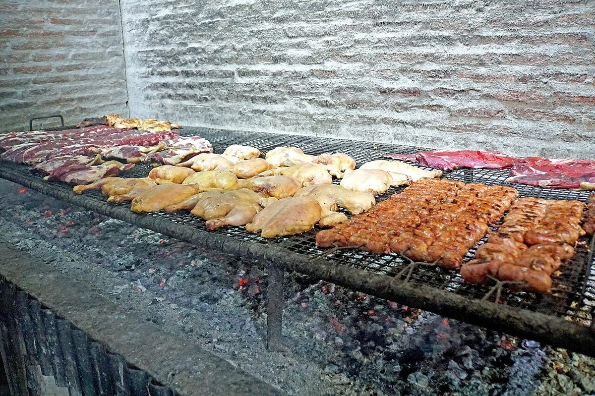 Chorizo sausages grilling on a parrilla for choripan