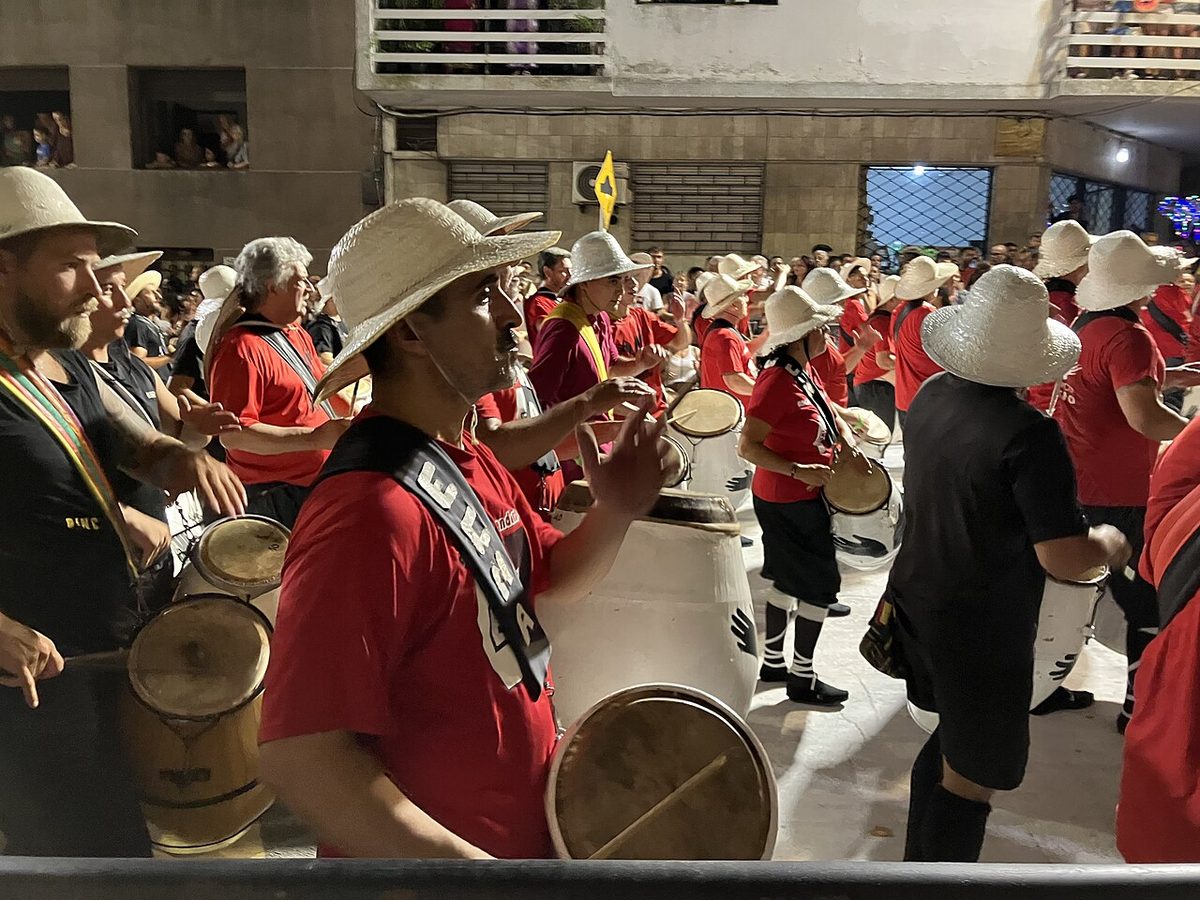 A cuerda de tambores playing the three candombe drums in a Montevideo street procession