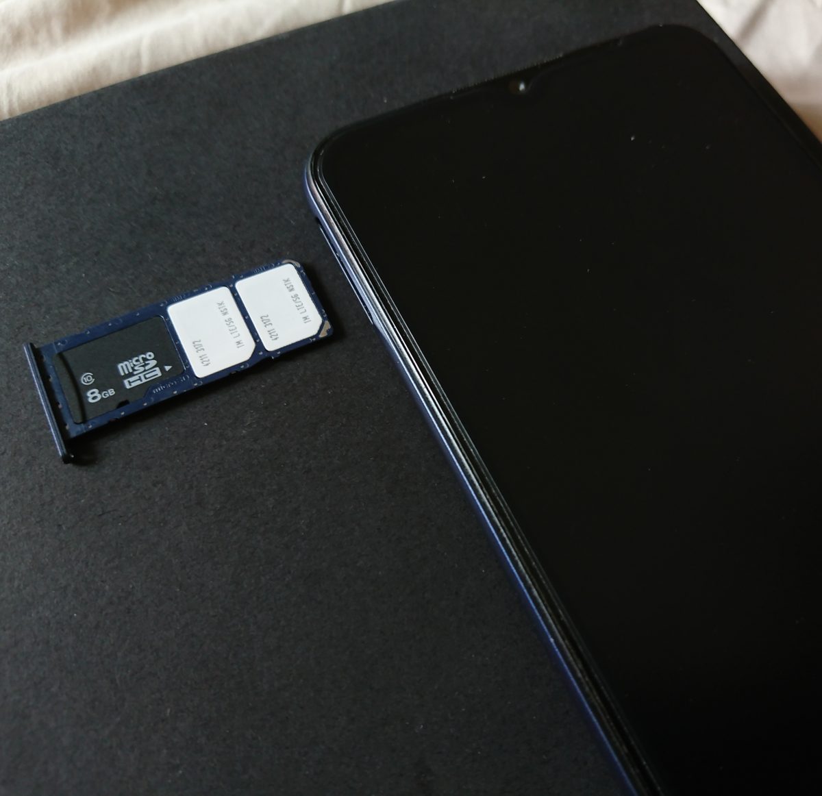 Slotting a SIM card into a smartphone