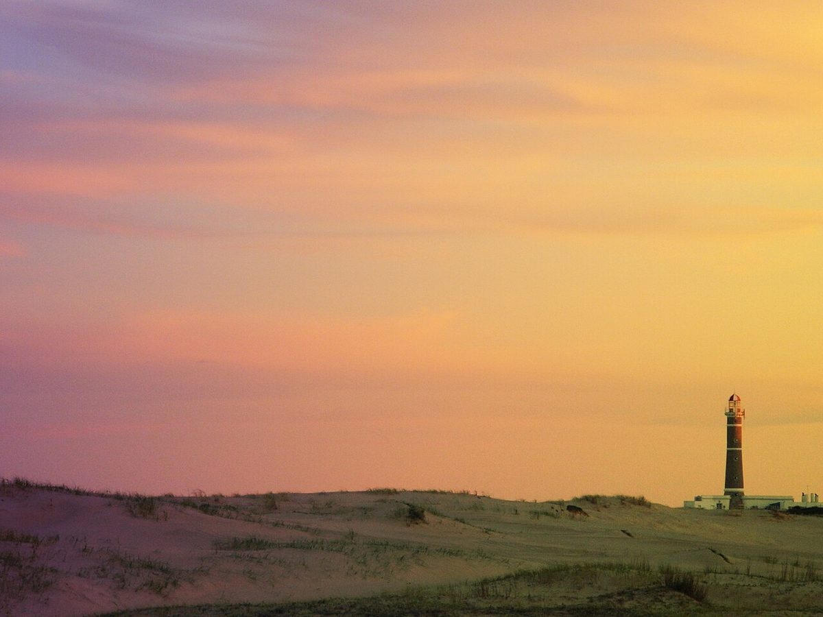 The Faro de José Ignacio lighthouse standing white against a blue sky in jose ignacio uruguay