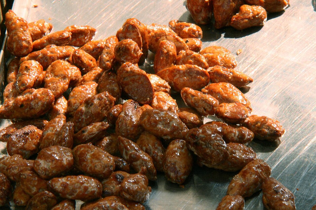 Garrapinada, the sugar-candied nuts sold warm by street carts
