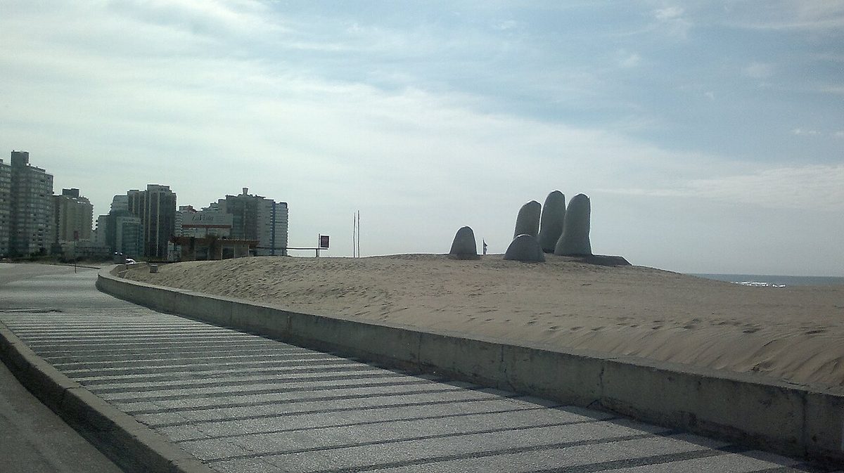 The concrete Hand sculpture (La Mano) emerging from the sand at Playa Brava in Punta del Este