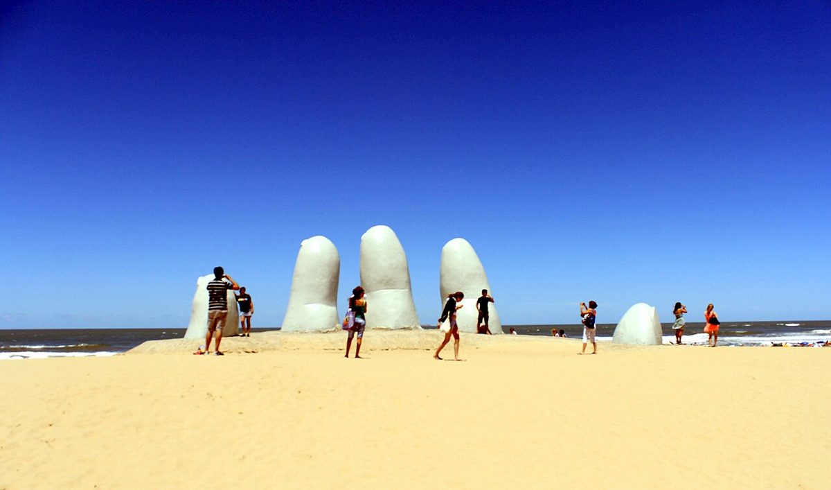 The fingers of La Mano rising from the beach in soft early light