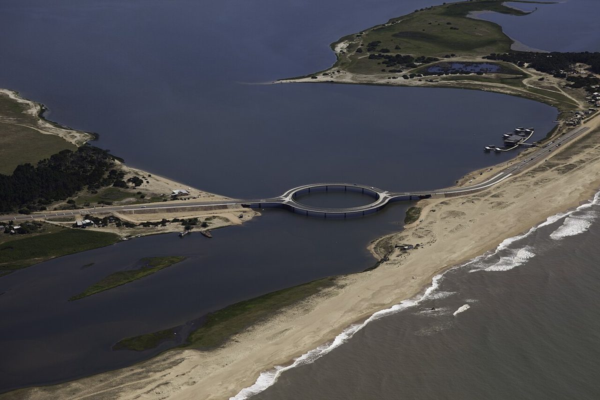 Aerial view of the circular Laguna Garzon bridge between the lagoon and the ocean