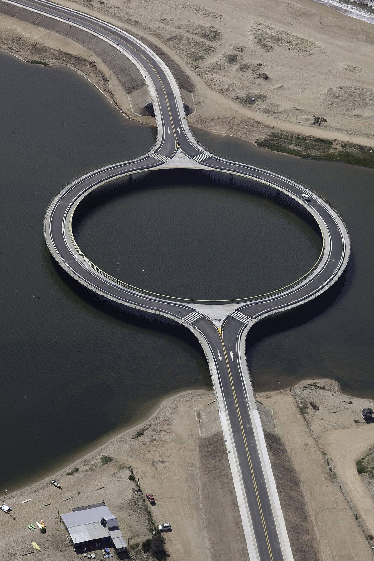 The circular ring road of the Puente Laguna Garzon seen from ground level over the water