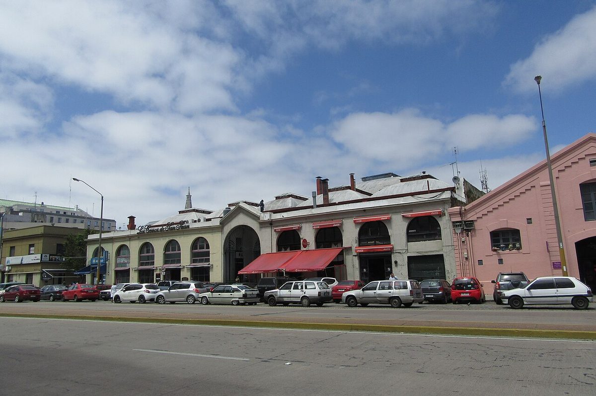 A diner paying by card at a parrilla restaurant in the Mercado del Puerto in Montevideo