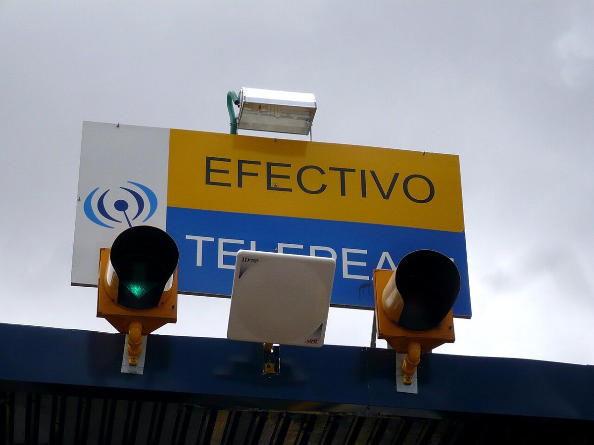 A cashless peaje toll plaza on a Uruguayan highway with automatic barriers