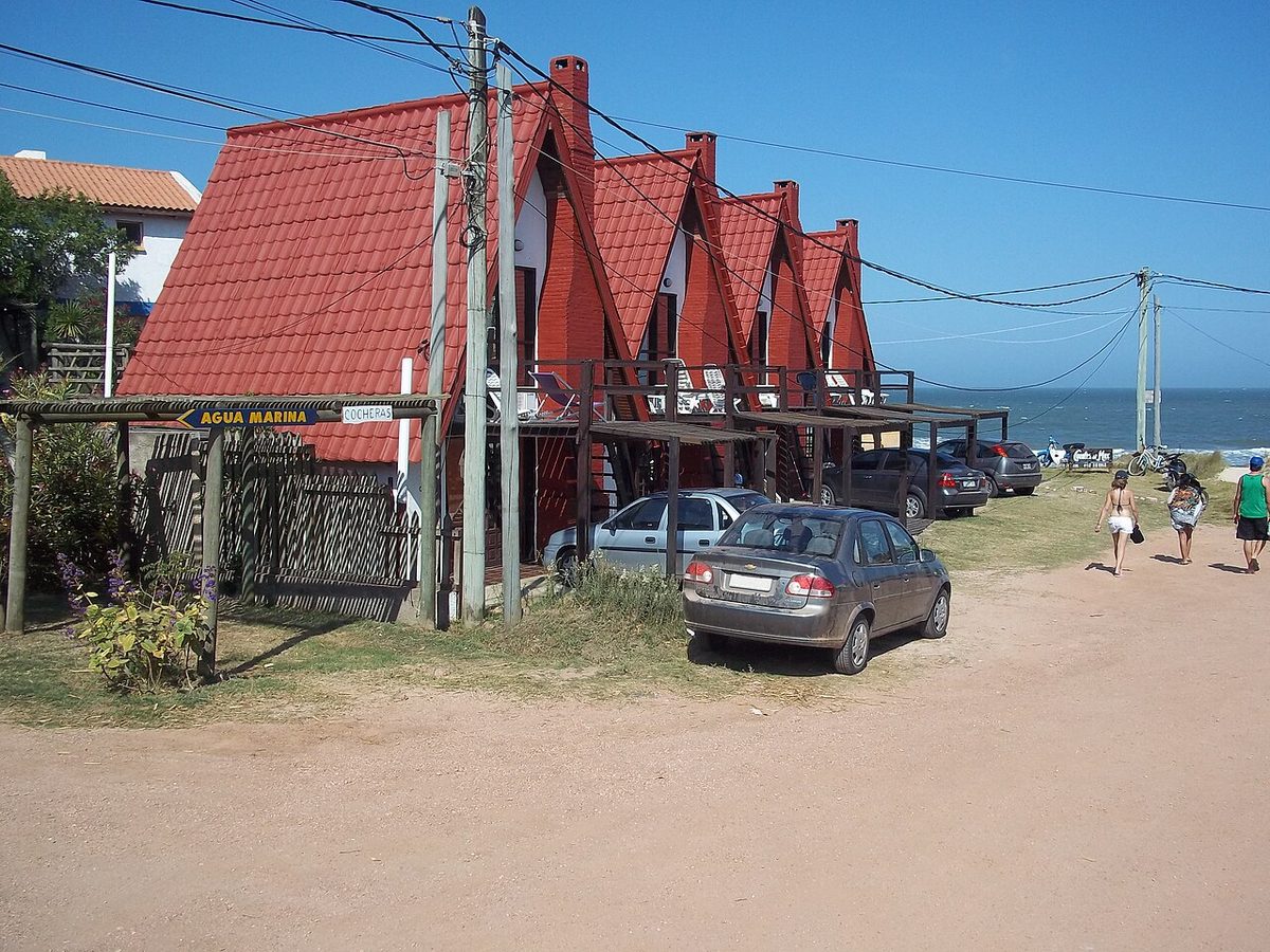 Brightly painted wooden cabanas on a sandy ripio street in the fishing village