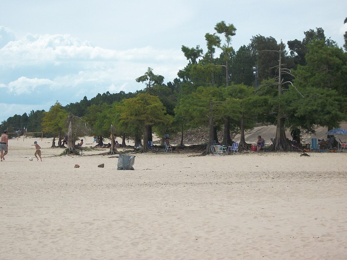 Sandy freshwater beach on the Rincon del Bonete reservoir below the town in summer