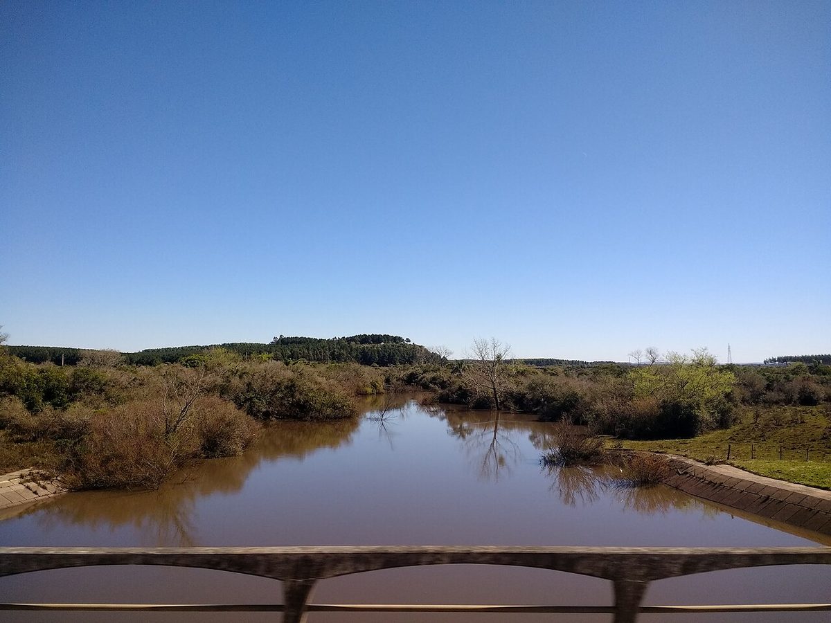 A river balneario bathing spot with trees and a sandy bank near Tacuarembo, Uruguay