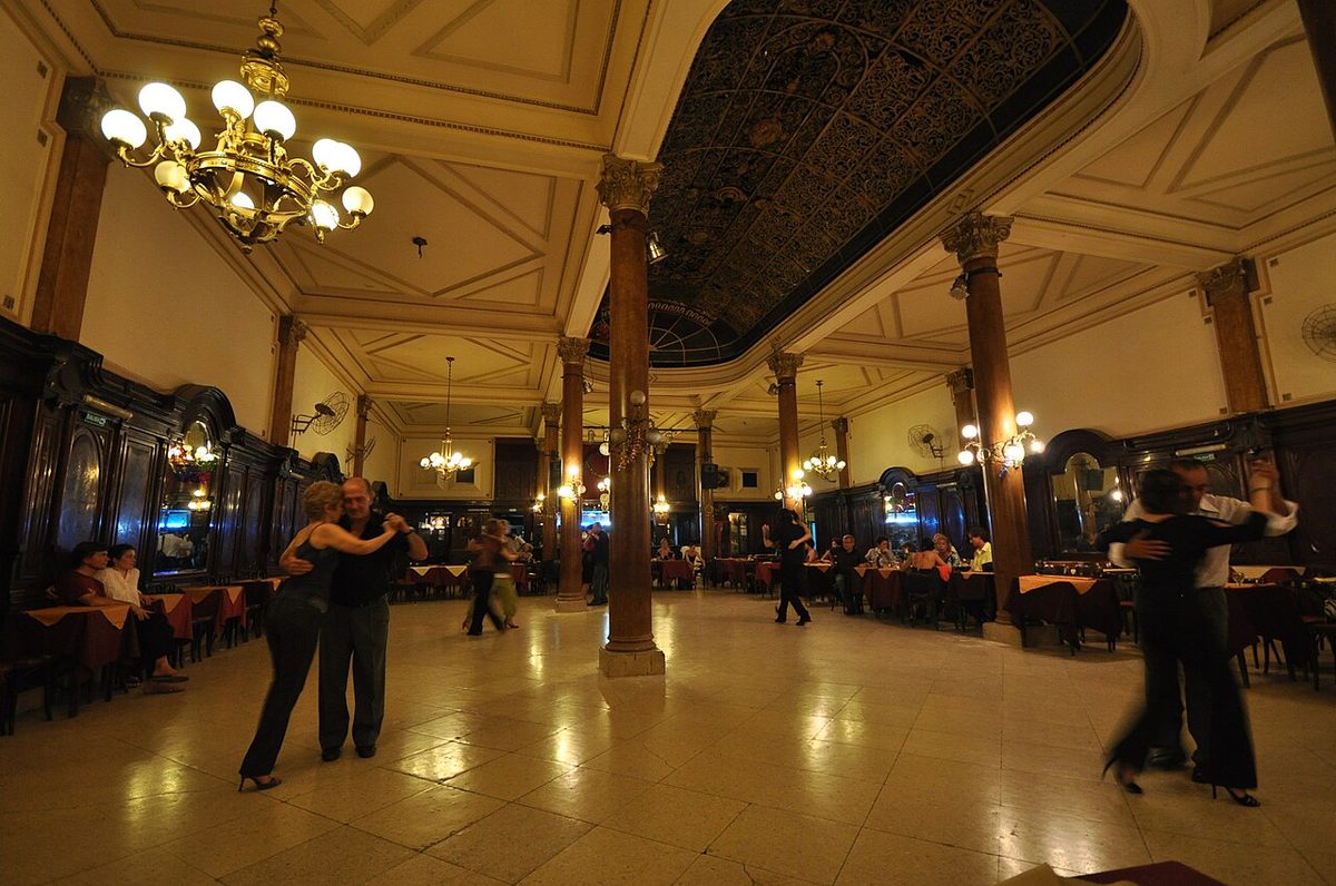 A couple dancing tango in montevideo at a local milonga