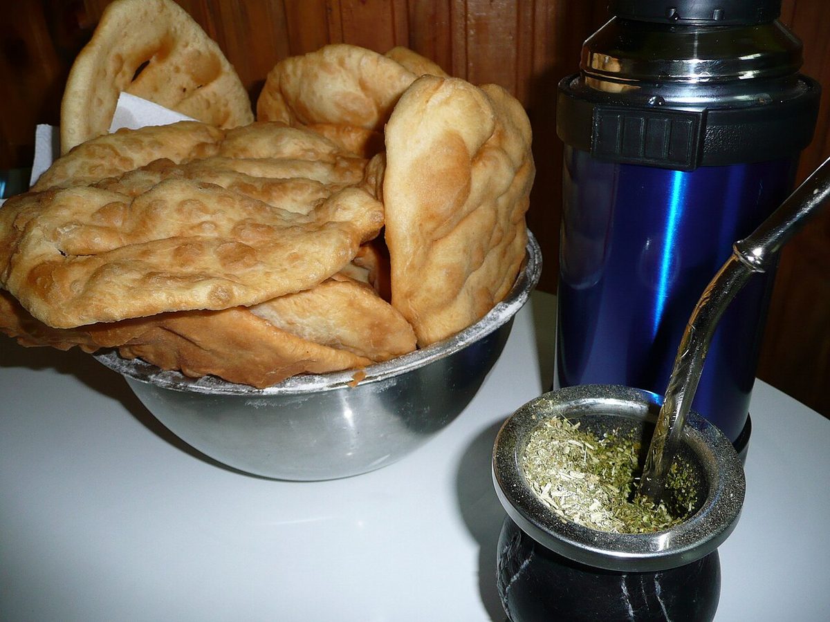 Uruguayan street food: tortas fritas, sugar-dusted fried dough discs, stacked on a plate