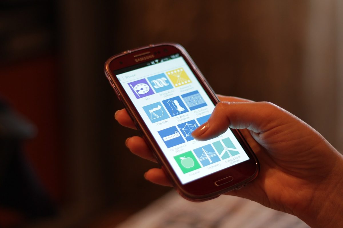 A traveler on a phone — a translation app covers the gaps when your Spanish runs out
