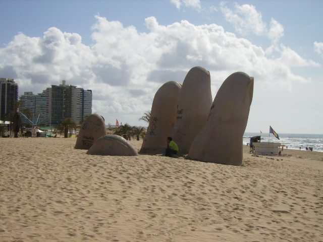 The fingers of the La Mano sculpture rising from the sand of Playa Brava, Punta del Este